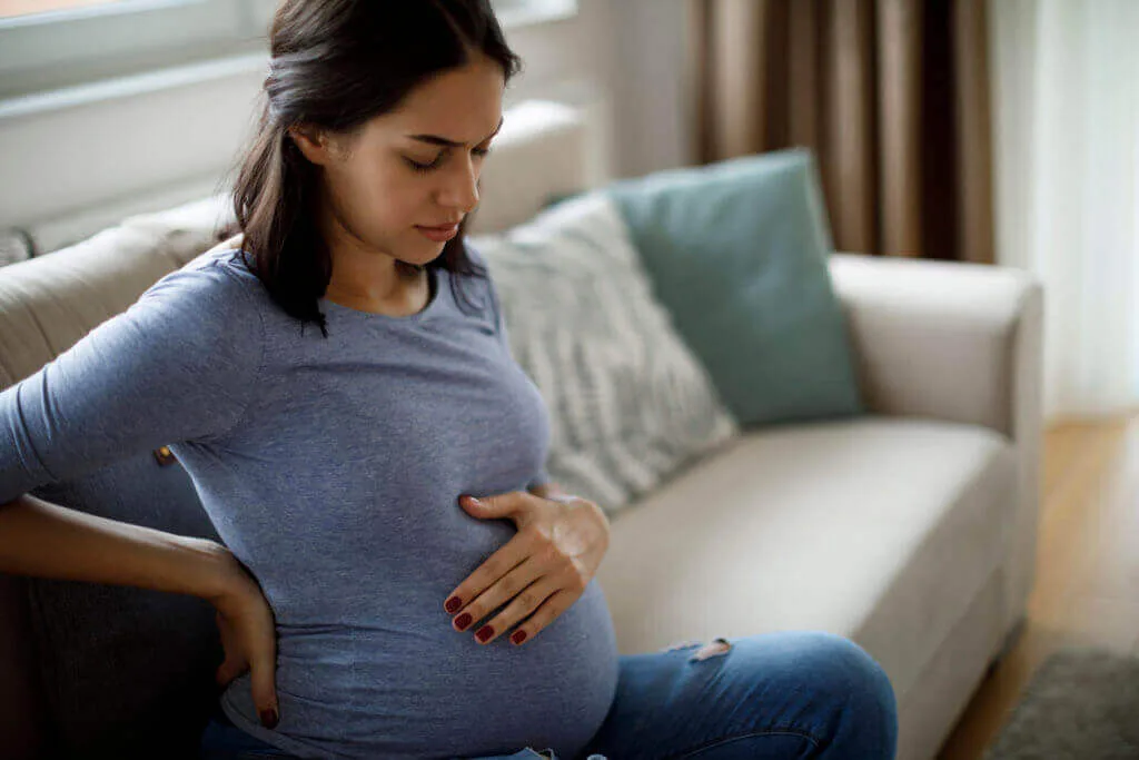 Pregnant woman experiencing discomfort
