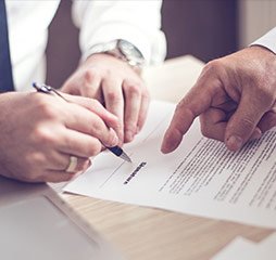 Two professionals review a contract