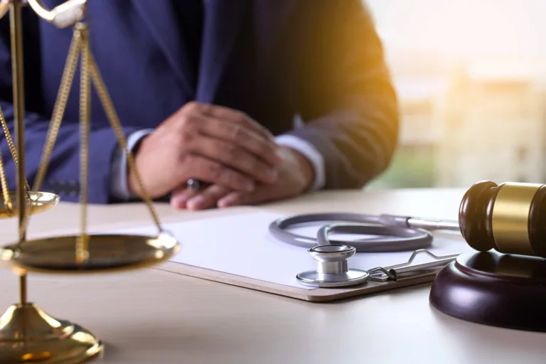 Doctor in handcuffs holding a stethoscope behind his back