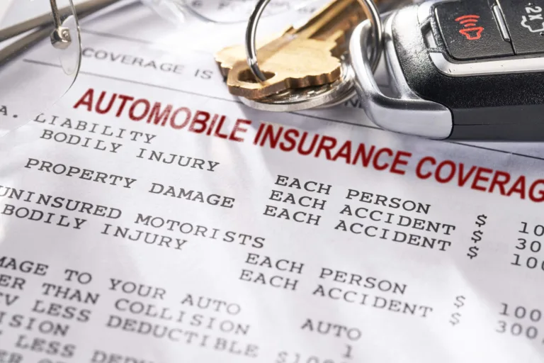 Car keys on an automobile insurance coverage document