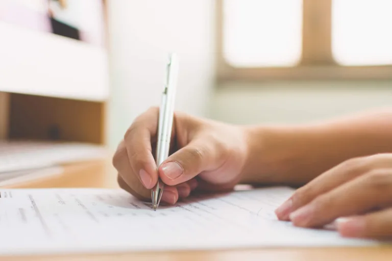 Person writing on legal document
