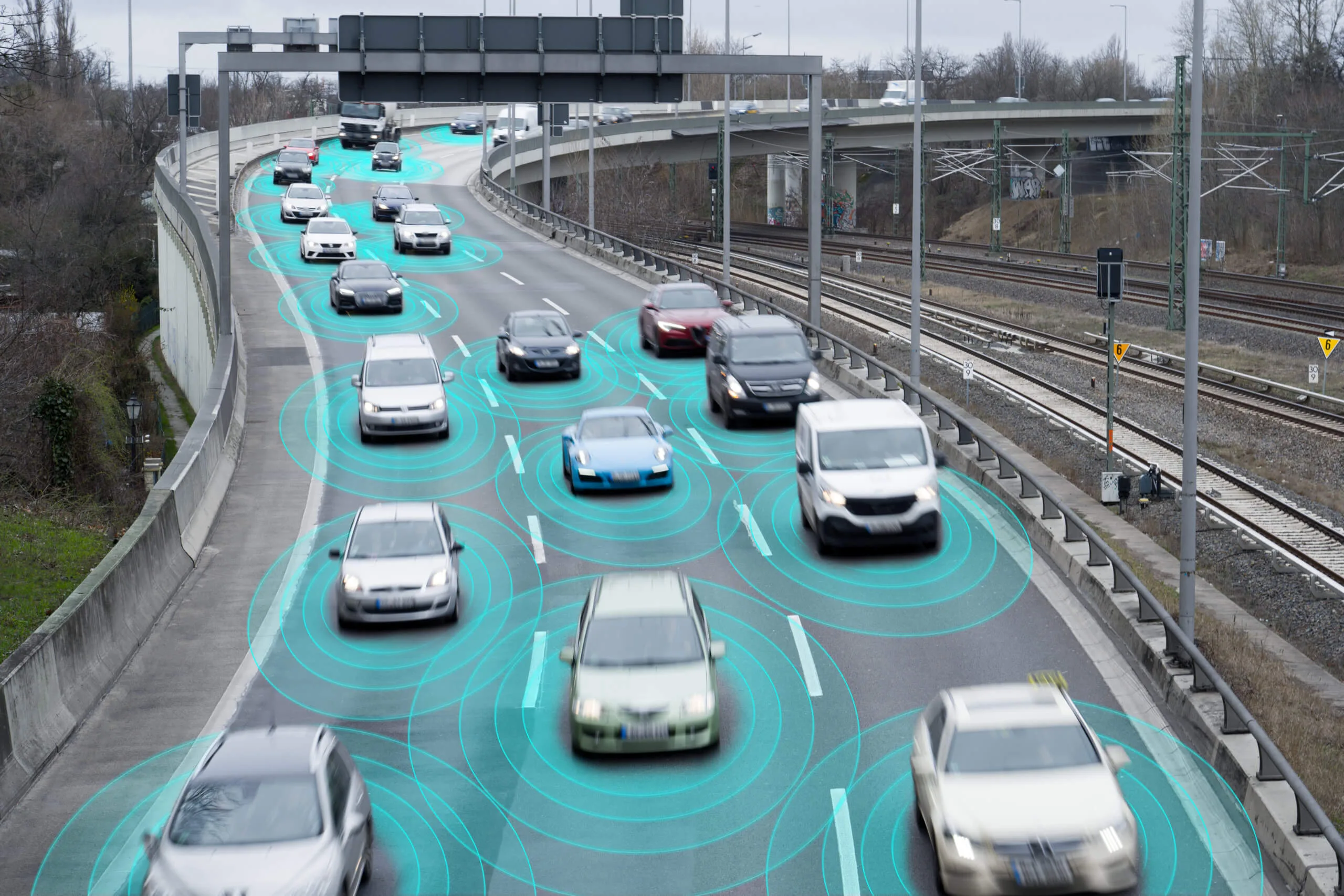 Highway of cars with teal sensor rings visualizing autonomous driving