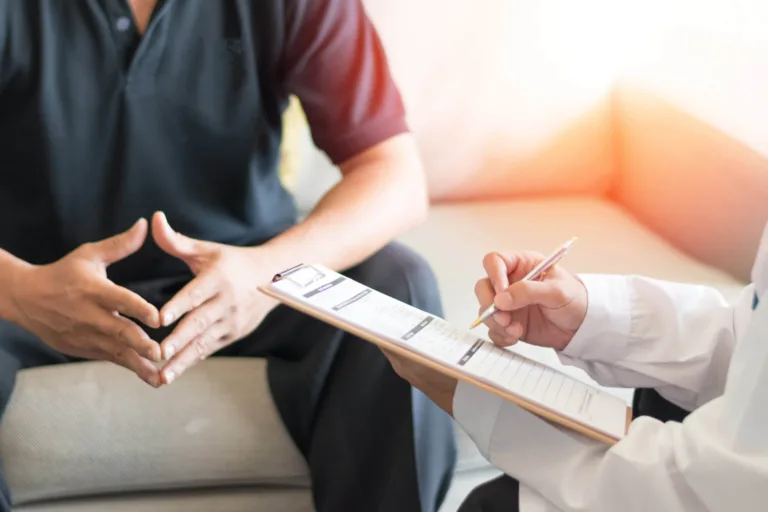 Man talking about spine injury with doctor