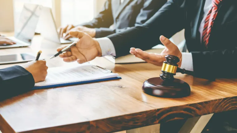 Attorneys meeting at conference table with gavel in foreground