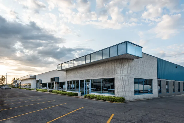 Commercial plaza / office-warehouse exterior with large parking lot