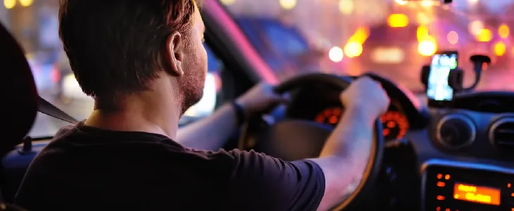 Man driving a car at night