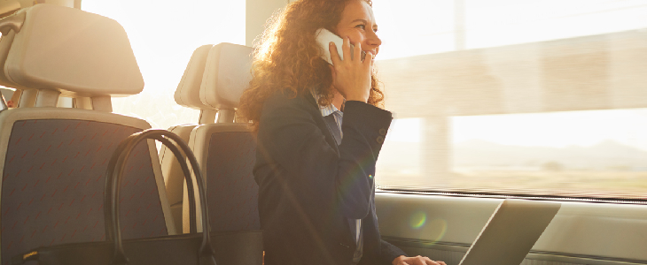 women inside a train talking on the phone