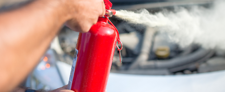 person using fire extinguisher due to vehicle defect