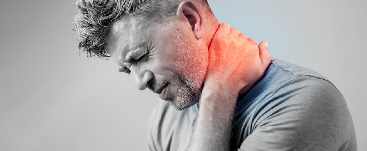 man feeling distressed due to whiplash injury and holding the back of his neck
