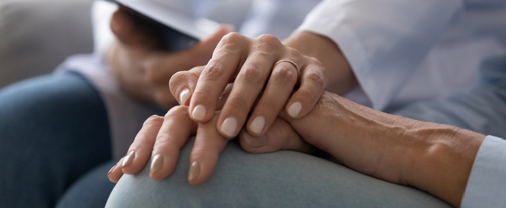 A doctor holding the hand of a patient