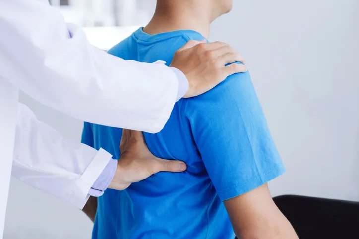 Man being examined by chiropractor