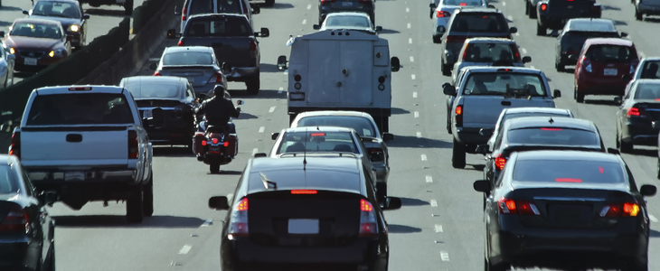 A motorcycle splitting lanes in traffic