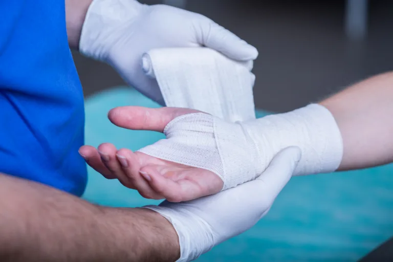 man being bandaged by doctor after dog bite attack