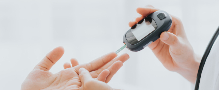 Doctor testing patients glucose levels