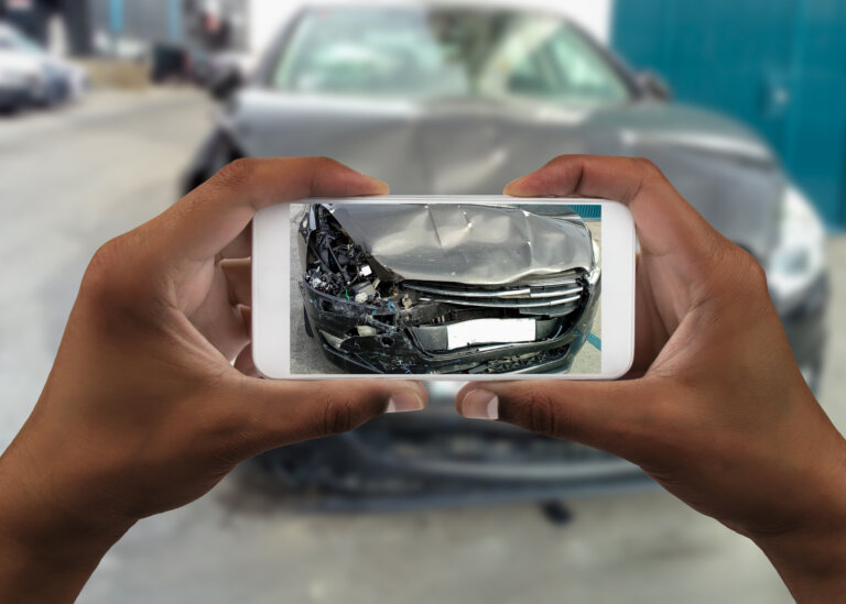 person taking a picture of a car accident