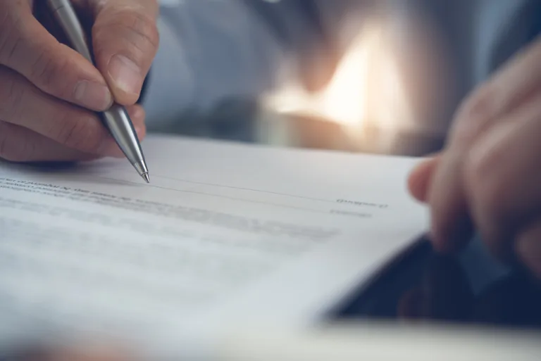 man signing settlements
