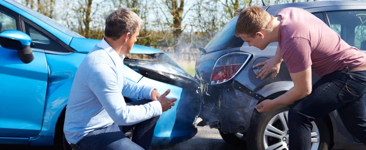 People arguing over a car accident