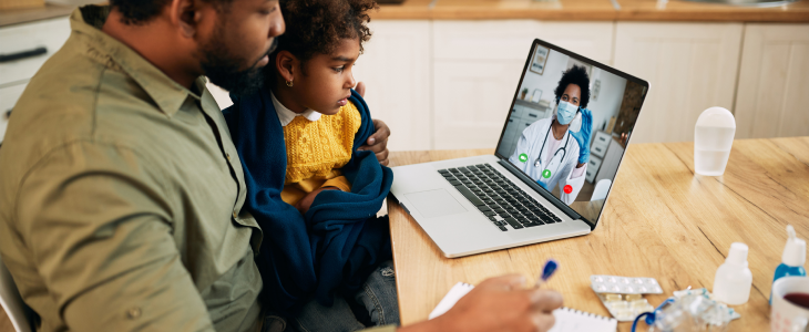 Father with his daughter during a Telehealth appointment