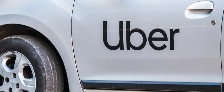 White car with the Uber logo on the side