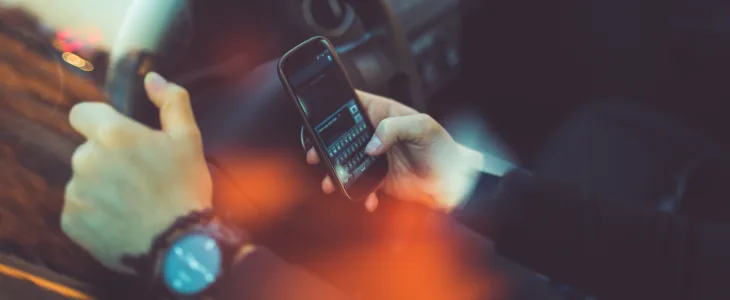 Man driving while texting on the phone