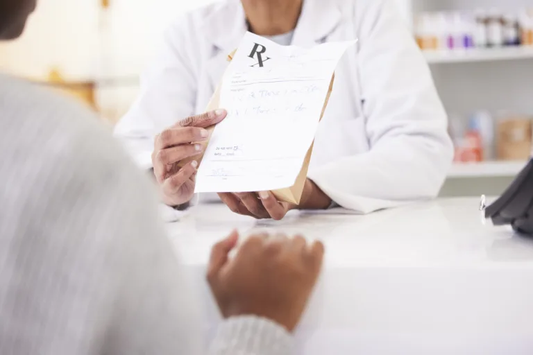 Doctor, hands and patient at pharmacy for medication prescription, drugs or consultation at store. Medical or healthcare professional consulting client on dosage for pharmaceutical product at clinic